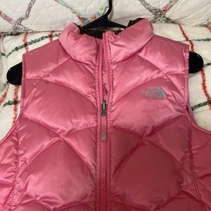 This is a youth size 14/16 / large  pink glossy , quilted Northface vest .